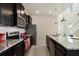 Well-equipped kitchen with granite counters and dark cabinets at 4428 Kaipo Rd, Davenport, FL 33897