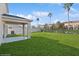 Large backyard with covered patio and grassy area at 5286 Tuscany Ln, Davenport, FL 33897