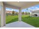 Covered patio overlooking a grassy backyard at 5286 Tuscany Ln, Davenport, FL 33897