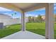 Covered patio with view of grassy backyard at 5286 Tuscany Ln, Davenport, FL 33897