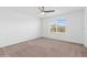 Bright bedroom with ceiling fan and window at 5286 Tuscany Ln, Davenport, FL 33897