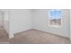 Well-lit bedroom featuring carpet flooring and a window at 5286 Tuscany Ln, Davenport, FL 33897