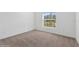 Simple bedroom with neutral carpeting and a large window at 5286 Tuscany Ln, Davenport, FL 33897