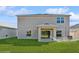 House back view, showcasing a patio and yard at 5286 Tuscany Ln, Davenport, FL 33897