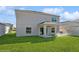 House back view showing backyard and patio at 5286 Tuscany Ln, Davenport, FL 33897