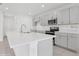 Modern kitchen with gray cabinets, white quartz countertops, and stainless steel appliances at 5286 Tuscany Ln, Davenport, FL 33897