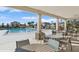 Relaxing pool area with tables and chairs at 5286 Tuscany Ln, Davenport, FL 33897
