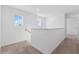 Upstairs hallway with carpeted floor and staircase at 5286 Tuscany Ln, Davenport, FL 33897