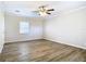 Bright bedroom featuring wood-look vinyl flooring and a ceiling fan at 537 E Desoto St, Clermont, FL 34711