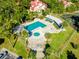 Aerial view of community pool, spa, tennis court, and surrounding landscape at 539 Heatherton Vlg, Altamonte Springs, FL 32714