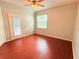 Spacious bedroom with wood flooring and sliding glass door to patio at 560 Cranes Way # 126, Altamonte Springs, FL 32701