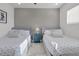 Guest bedroom with two twin beds and beach decor at 6133 High Seas Dr, Orlando, FL 32821