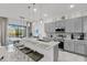 Modern kitchen with gray cabinets, stainless steel appliances, and a large island at 6133 High Seas Dr, Orlando, FL 32821