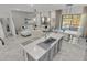 Modern kitchen island with gray cabinets and white countertops at 6133 High Seas Dr, Orlando, FL 32821