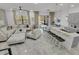 Open-concept living space with gray kitchen island, marble floors, and access to backyard at 6133 High Seas Dr, Orlando, FL 32821