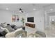 Bright living room featuring a sectional sofa and large TV at 6133 High Seas Dr, Orlando, FL 32821