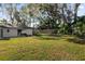 Spacious backyard with lush grass and trees at 8 Pine Ct, Yalaha, FL 34797