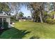 Large backyard with lush grass and mature trees at 8 Pine Ct, Yalaha, FL 34797