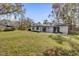 Spacious backyard with grassy lawn, providing ample outdoor space at 8 Pine Ct, Yalaha, FL 34797