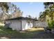 White house exterior with a gray roof and a fenced yard at 8 Pine Ct, Yalaha, FL 34797