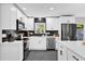 Modern white kitchen with black tile backsplash at 8 Pine Ct, Yalaha, FL 34797