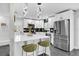 Updated kitchen featuring white cabinets and a breakfast bar at 8 Pine Ct, Yalaha, FL 34797
