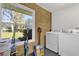 Convenient laundry room with washer, dryer, and window at 8 Pine Ct, Yalaha, FL 34797