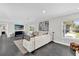 Living area with comfortable seating and large TV at 8 Pine Ct, Yalaha, FL 34797