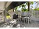 Outdoor patio with seating area and grill at 8 Pine Ct, Yalaha, FL 34797