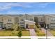 Modern two-story home with a yellow garage and landscaping in a residential area at 8940 Play Through Dr, Davenport, FL 33896