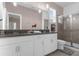 Elegant bathroom with double vanity and a walk-in shower at 8940 Play Through Dr, Davenport, FL 33896