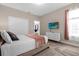 Bright bedroom featuring a comfortable bed and large TV at 8940 Play Through Dr, Davenport, FL 33896