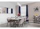Modern dining room with a large white table and navy blue chairs at 8940 Play Through Dr, Davenport, FL 33896