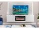 Modern electric fireplace with marble surround and built in shelving at 8940 Play Through Dr, Davenport, FL 33896