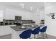 Modern kitchen with white cabinets, breakfast bar, and stainless steel appliances at 8940 Play Through Dr, Davenport, FL 33896