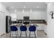 Modern kitchen with white cabinets, breakfast bar, and stainless steel appliances at 8940 Play Through Dr, Davenport, FL 33896
