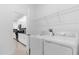 Bright laundry room with washer, dryer, and kitchen view at 8940 Play Through Dr, Davenport, FL 33896