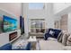 Living area featuring a sectional sofa, large TV, electric fireplace and access to backyard at 8940 Play Through Dr, Davenport, FL 33896