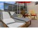 Relaxing lounge chairs under a red umbrella near the spa at 8940 Play Through Dr, Davenport, FL 33896