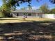 Large backyard with a fire pit and a white fence at 1111 South St, Eustis, FL 32726