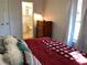 Bedroom with view into bathroom and dresser at 1111 South St, Eustis, FL 32726