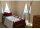Bedroom with twin bed, dresser, and natural light from two windows at 1111 South St, Eustis, FL 32726