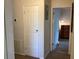 Hallway with doors to bedrooms and electrical panel at 1111 South St, Eustis, FL 32726
