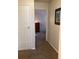 Hallway with doors to bedrooms and carpet flooring at 1111 South St, Eustis, FL 32726