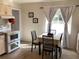 Kitchen with electric range, dining area, and window overlooking backyard at 1111 South St, Eustis, FL 32726