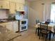 Kitchen with white cabinets, double oven, and adjacent dining area at 1111 South St, Eustis, FL 32726