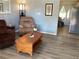 Living room featuring a recliner, coffee table, and wood-look flooring at 1111 South St, Eustis, FL 32726