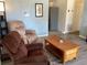 Living room with recliner, coffee table, and view into kitchen at 1111 South St, Eustis, FL 32726