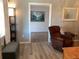 Living room with two chairs, a coffee table, and a view into another room at 1111 South St, Eustis, FL 32726