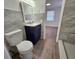 Updated bathroom with navy vanity, tile flooring, and a walk-in shower at 1503 33Rd Nw St, Winter Haven, FL 33881